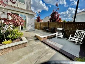 two white chairs sitting on a patio in front of a house at The haven @ Roc Sac in Rocklin