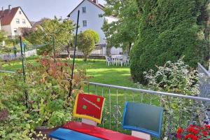 two colorful chairs sitting in a garden at Cosy Holiday Home in Mohnesee in Möhnesee