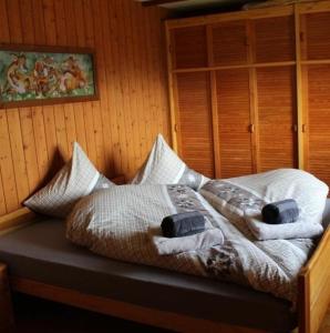 a bedroom with a bed with towels on it at Sennastübli in Bühler