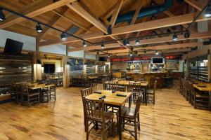 a dining room with wooden tables and chairs at Great Wolf Lodge Wisconsin Dells in Wisconsin Dells