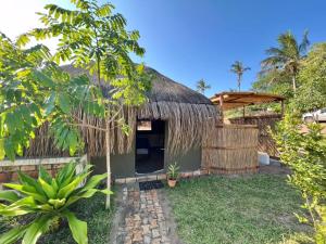 a small house with a thatched roof at Vista Do Deus Resort in Ligogo