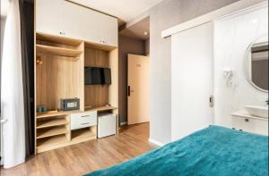 a bedroom with a bed and a sink and a mirror at Hotel Babi in Tbilisi City