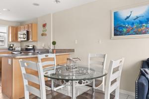a kitchen and dining room with a glass table and chairs at Beachview OC 2 Ocean Block in Ocean City