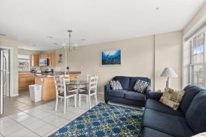 a living room with a blue couch and a kitchen at Beachview OC 2 Ocean Block in Ocean City +17 photos