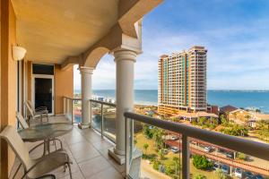 a balcony with a view of the ocean at 1 Portofino 1005 at Pensacola Beach in Pensacola Beach