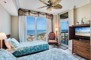 a bedroom with a view of the ocean at 1 Portofino 1005 at Pensacola Beach in Pensacola Beach