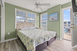 a bedroom with a bed and two windows at Beachview OC 4 in Ocean City