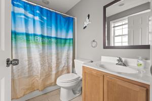 a bathroom with a toilet and a sink and a shower curtain at Beachview OC 4 in Ocean City +22 photos