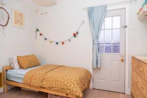 a bedroom with a bed and a window at Bright 3 bedroom house Downtown in Toronto