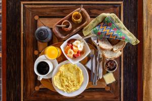 a tray of breakfast food with eggs and toast at Hostería Mandála in Puerto López