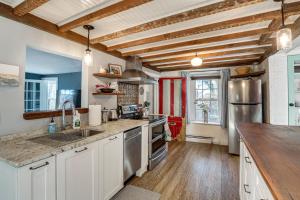 a kitchen with white cabinets and a wooden ceiling at Lambertville Retreat - Walk to Shopping and Dining! in Lambertville