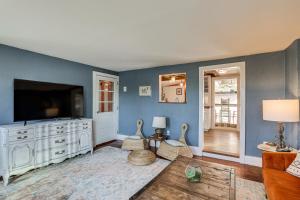 a living room with blue walls and a flat screen tv at Lambertville Retreat - Walk to Shopping and Dining! in Lambertville