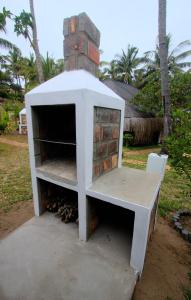 a brick oven with a table in front of it at Vista Do Deus Resort in Ligogo