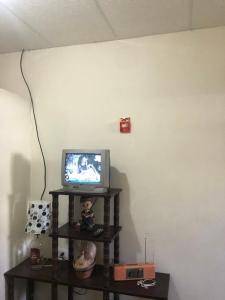 - une télévision assise sur une étagère dans une pièce dans l'établissement Hospedaje Maluli Suit Ricardo, à Santa Elena