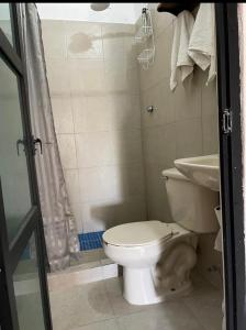 a bathroom with a toilet and a sink at Casa bugambilias in Cabo San Lucas