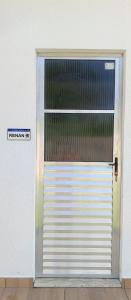a garage door with a gate in a building at Suítes com piscina Praia do Forte Tomas in Praia do Forte
