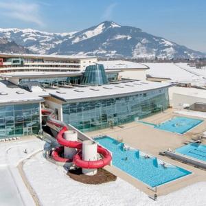 a large building with a swimming pool and a resort at Appartement Paulina Kaprun in Kaprun +26 photos