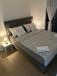a bedroom with a large bed with white pillows at MM Apartments Zore in Zagreb