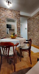 comedor con mesa y 2 sillas en Lux Apartment Rose 2 60m2, en Kragujevac