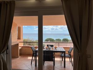 a dining room with a table and a view of the ocean at Villa Elma in Villaputzu