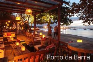 a restaurant with a view of the water at night at Canto sossego casa independente a passos do mar in Búzios