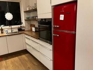 a red refrigerator in a kitchen with a window at Private room in a shared apartment with amazing view in Reykjavík