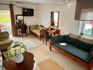 a living room with a couch and a table at LA SAN PEDRO I Laganas Karydakis in Laganas