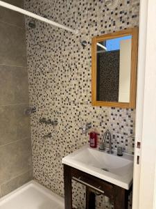 a bathroom with a sink and a mirror and a shower at Condo Costa Azul in Costa Azul