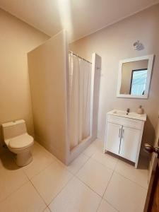 ein Badezimmer mit einem WC, einem Waschbecken und einem Spiegel in der Unterkunft La Nómada Digital - Máncora Playa & Piscina in Máncora
