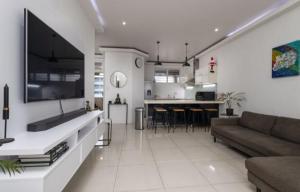 a large living room with a couch and a kitchen at The Views BNB in Durban