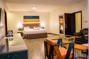 a bedroom with a bed and a living room at Grazia Apartment Hotel in Kigali +102 photos