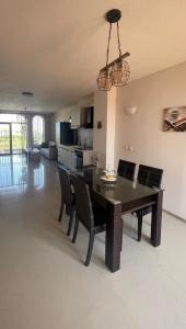 a dining room and living room with a table and chairs at Private Apartment with Sea View in Sozopol