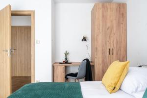a bedroom with a bed and a desk at Ornak 7 in Zakopane