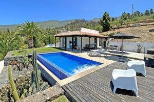 a villa with a swimming pool on a wooden deck at Ferienhaus für 2 Personen ca 50 qm in Tijarafe, La Palma Westküste von La Palma in Tijarafe