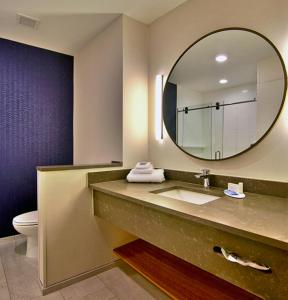 a bathroom with a sink and a mirror at Fairfield Inn & Suites by Marriott Nashville Airport in Nashville