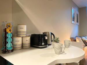a counter top with a coffee maker and cups on it at HNFC Stays - Corporate Central Studios + Parking in Newcastle upon Tyne