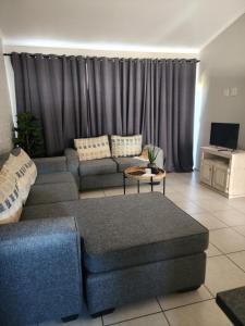 a living room with a couch and a table at Home@Micasa in Potchefstroom