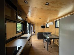 Una pequeña casa con cocina y zona de comedor en Havelock North Holiday Park, en Havelock North