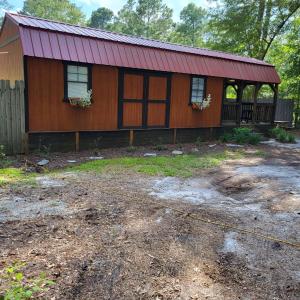 a house with a red roof and a yard at Fern Gully cabin in Conway