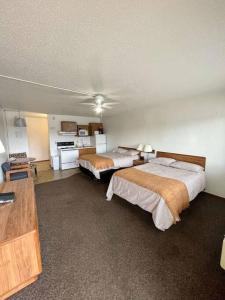 a hotel room with two beds and a kitchen at #28 Snooze in Wisconsin Rapids