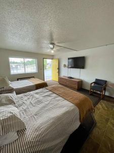 a bedroom with two beds and a flat screen tv at #28 Snooze in Wisconsin Rapids