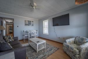 a living room with a couch and a tv at Boardwalk1009-6 in Ocean City