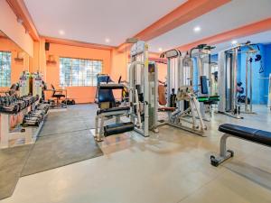 a gym with rows of treadmills and machines at Super OYO RK Club House in Kammasandra