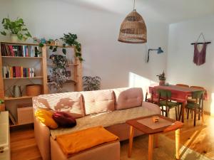 a living room with a couch and a table at Apartament Borówka in Jedlina-Zdrój