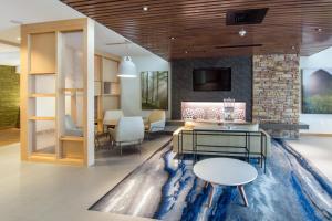 a living room with a table and chairs at Fairfield Inn & Suites by Marriott Nashville Airport in Nashville