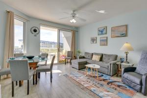 a living room with a couch and a table at Sunny Fort Walton Beach Condo - Walk to Ocean! in Fort Walton Beach