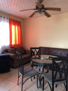 a living room with a table and chairs and a couch at The Green House in Bocas del Toro