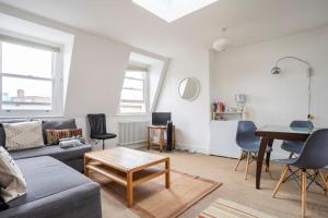 a living room with a couch and a table at North East London loft apartment. Stoke Newington. in London