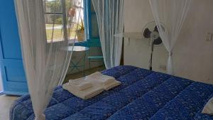 ein Schlafzimmer mit einem Bett mit Handtüchern darauf in der Unterkunft Habitación payesa en el bosque, La Barra in Barra de Maldonado
