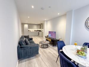 a living room with a couch and a table at Apex Lofts Suite - Modern 2 bed with rooftop terrace in Birmingham